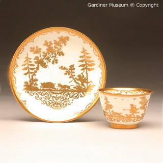 Teabowl and saucer with hunting scenes painted in the Seuter workshop