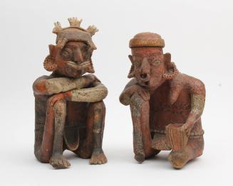 Emaciated male and female seated figures