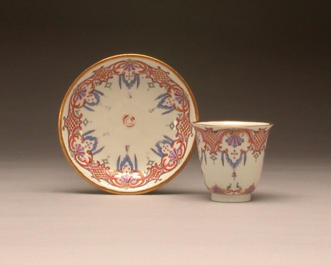 Beaker and saucer with Laub- und Bandelwerk border