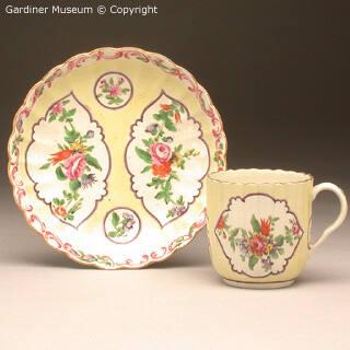 Coffee cup and saucer with yellow ground and flora