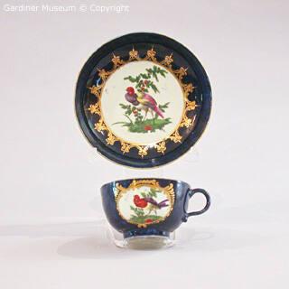 Teacup and saucer with bird