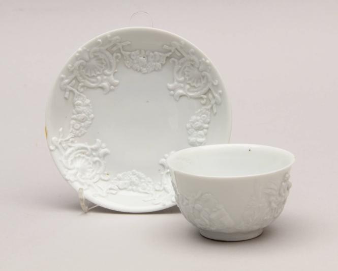 Teabowl and saucer, relief moulded