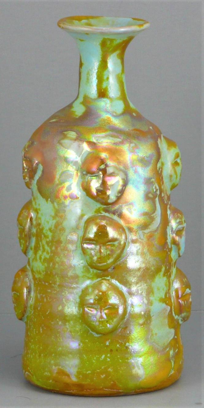 Bottle vase with masks
