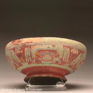 Bowl with four faces wearing headdresses