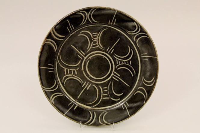 Set of eight plates with incised decoration