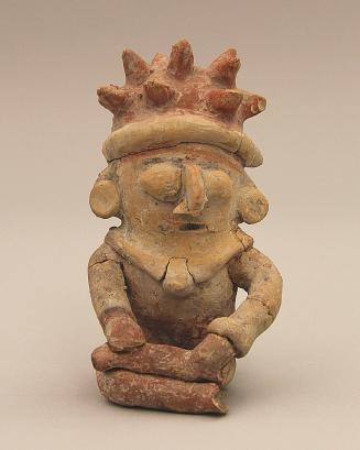 Seated figure with spiked headdress