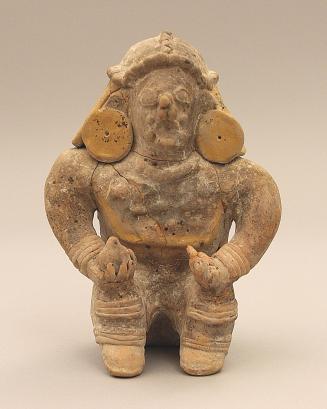 Seated figure with hands on knees